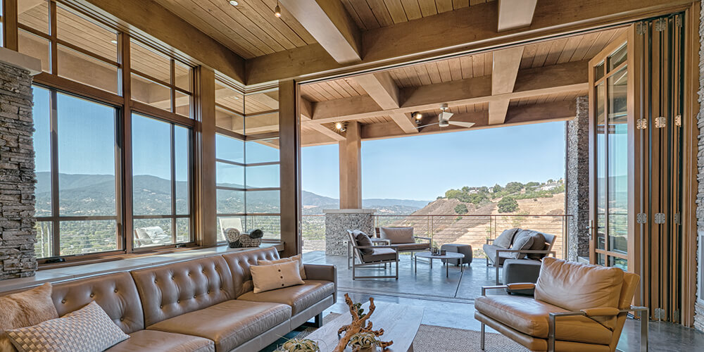 Custom-crafted wood folding doors embrace breathtaking views of the landscape. AA528